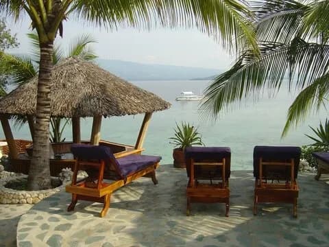 Sun loungers on the beach at Magic Island Dive Resort, Philippines. Sun loungers on the beach at Magic Island Dive Resort, Philippines.